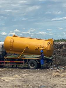 Waste truck in front of garbage dump