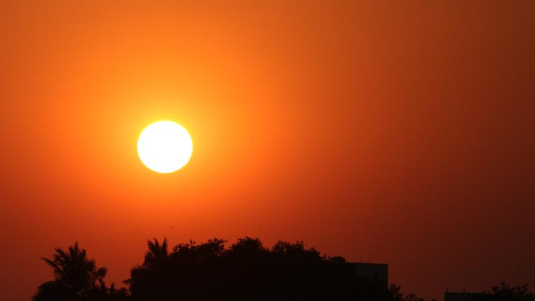 A yellow sun in a red sky.