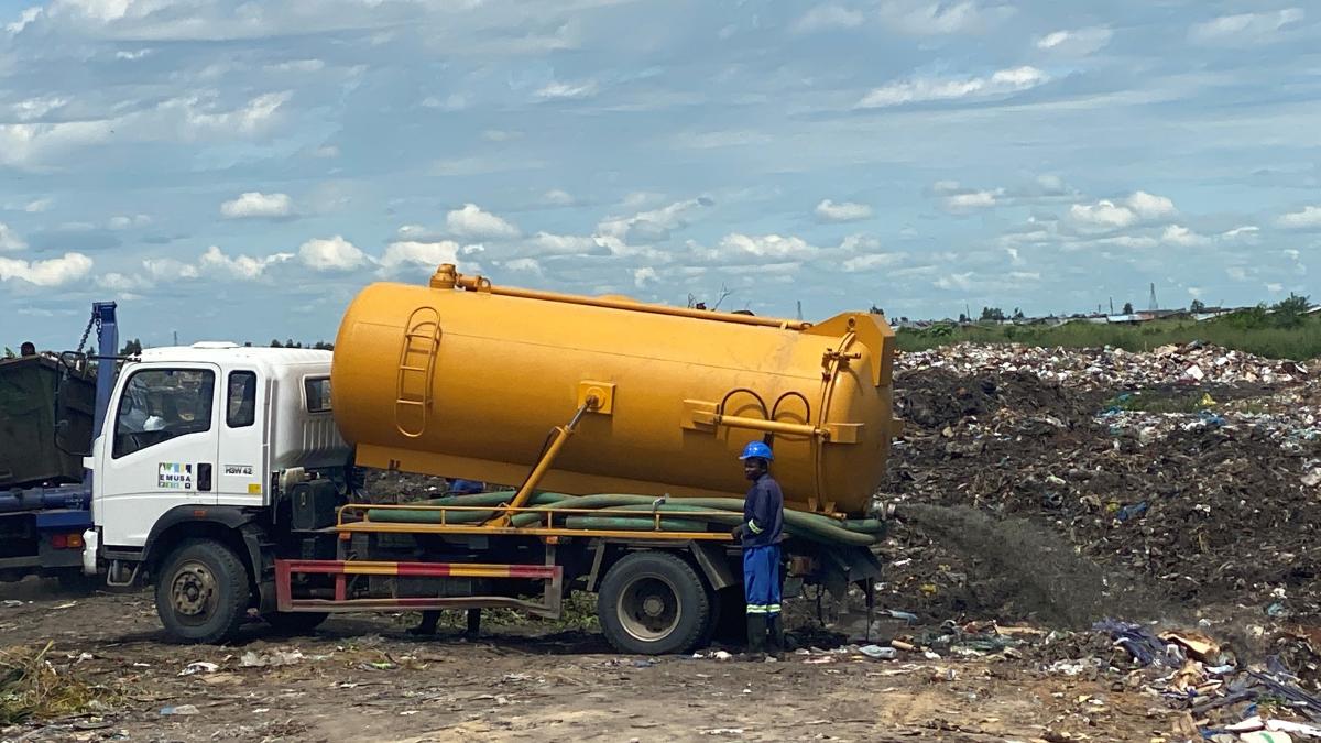 Waste truck in front of garbage dump