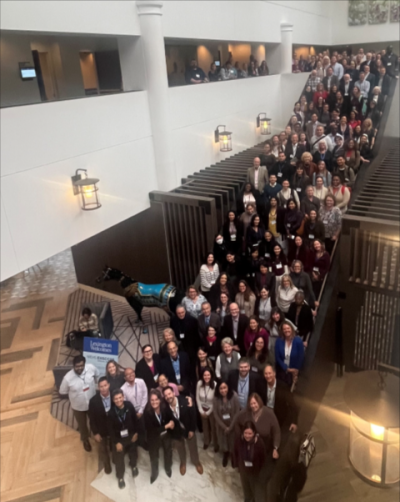 A large group of over 100 people assembled on a staircase